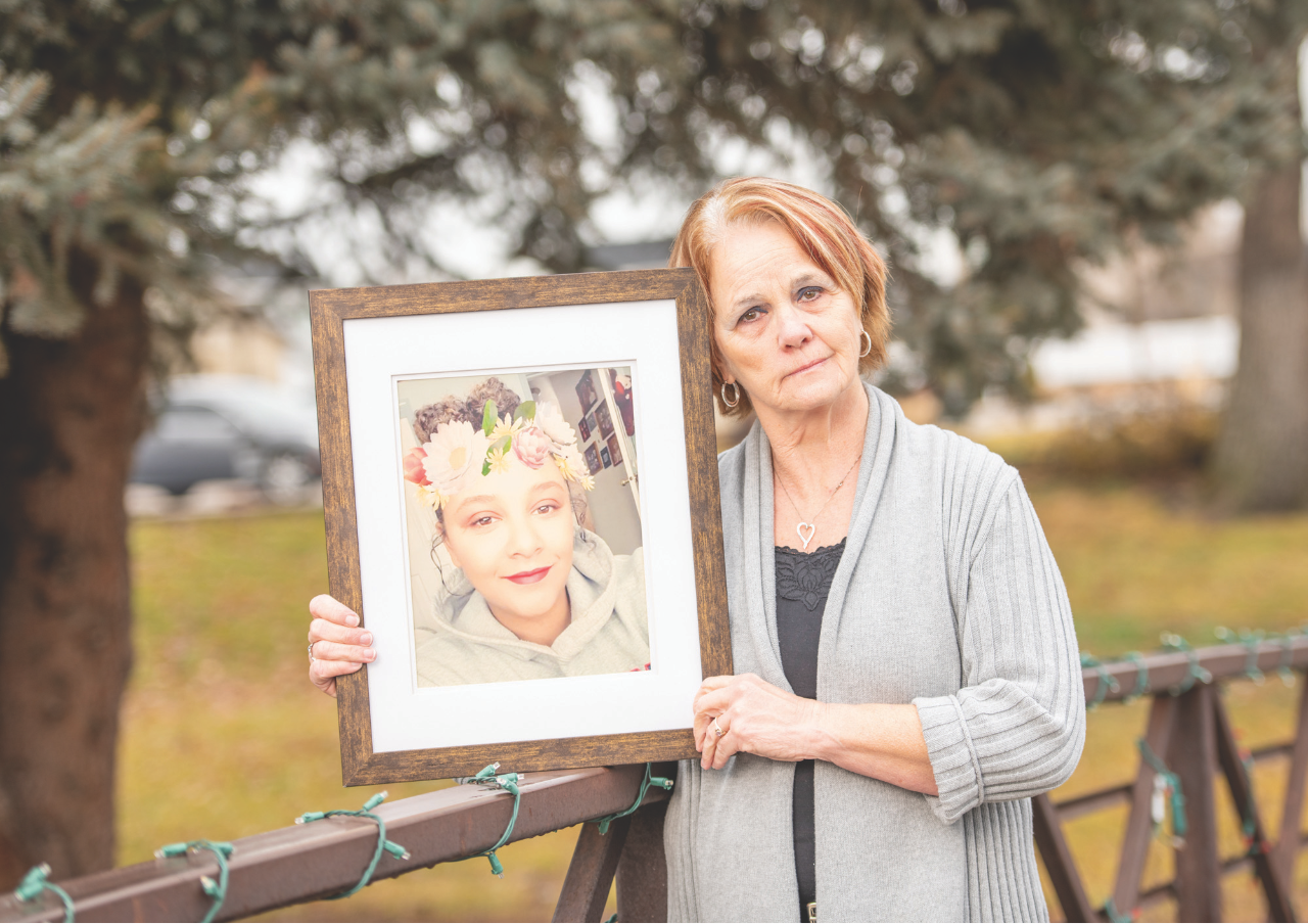 Mother holding picture of daughter